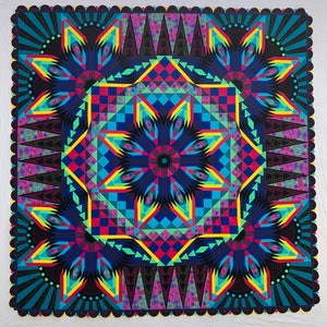 May include: A colorful quilt with a geometric pattern in shades of blue, green, red, yellow, and black. The quilt is made up of many different shapes and sizes, and it has a central starburst design.