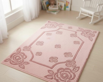 Alfombra rosa suave con relieve floral: elegante alfombra con estampado de rosas para dormitorio o habitación infantil.
