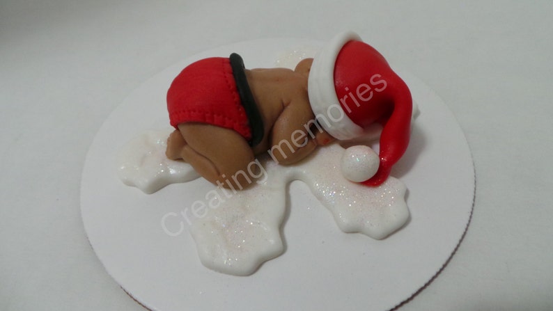 He is ready for the holidays Baby Boy in a Christmas Outfit Cake Topper Made of Vanilla Fondant