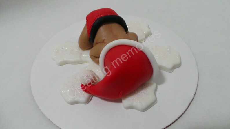 He is ready for the holidays Baby Boy in a Christmas Outfit Cake Topper Made of Vanilla Fondant