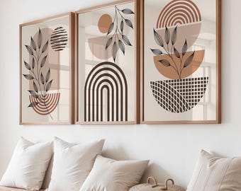 May include: Three framed wall art prints featuring abstract geometric shapes and black line-drawn botanical leaf motifs in shades of terracotta, beige, and dark brown. The artwork displays semi-circles, arches, and grid patterns on a light background.
