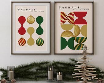 May include: Two framed wall art prints featuring Bauhaus style graphic designs in red, gold, and green. The left print displays abstract shapes and ornaments with the text Bauhaus Dec-Jan-Feb 1923. The right print shows geometric patterns.