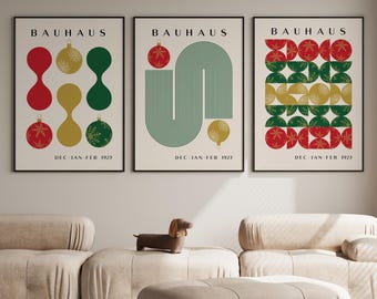 May include: Three vertical posters with black frames featuring Bauhaus-style geometric designs in red, green, and gold. Each print displays the text BAUHAUS at the top and DEC-JAN-FEB 1925 at the bottom, incorporating circular ornament motifs.