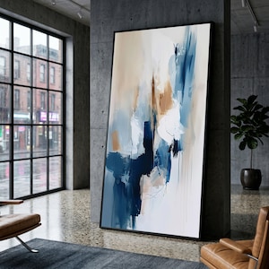 Pode incluir: Uma grande pintura abstrata vertical numa moldura preta com pinceladas largas e expressivas em tons de azul marinho, azul claro, branco e bege. A composição apresenta texturas de tinta em camadas com movimento fluido.
