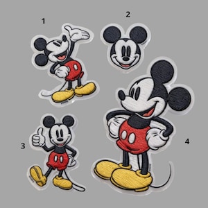 May include: Four embroidered patches featuring Mickey Mouse in various poses. Mickey is depicted with black ears, a white face, red shorts, yellow shoes, and white gloves. The patches are on a gray background.