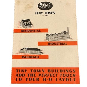 May include: A vintage Ideal Models Tiny Town 1/8 inch scale instruction booklet with a cream background. It features black and white illustrations of residential, industrial, and railroad buildings with orange accents and black text throughout.