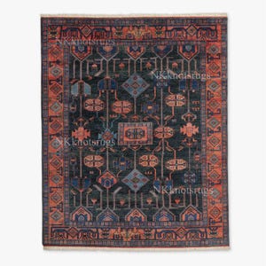 Könnte beinhalten: Ein rechteckiger, dunkelblauer Teppich mit einem komplizierten geometrischen Muster. Das Design zeigt sich wiederholende Formen in Orange-, Blau- und Türkistönen mit einem detaillierten Rand. Der Text "NKknotsrugs" ist sichtbar.