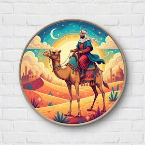 May include: Round wall art featuring a desert scene with a person riding a camel. The artwork has a warm color palette with a bright sun, a crescent moon, and buildings in the background. The rider wears a turban and a long robe.