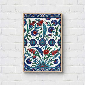 May include: A rectangular framed wall art piece featuring a white background with a repeating pattern of red tulips, blue carnations, and green leaves. The design is bordered by a decorative blue and white floral band at the top and bottom edges.