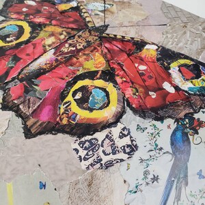 May include: A collage of paper featuring a large butterfly with red, yellow, and blue accents. The butterfly is surrounded by smaller butterflies and floral patterns.