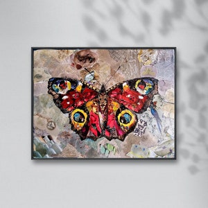 May include: A colorful butterfly collage artwork with red, yellow, blue, and black accents. The butterfly is framed in a black frame and set against a textured background.
