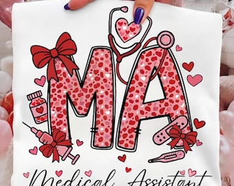 May include: A white t-shirt featuring the letters MA in a pink and red leopard print pattern. The design includes a stethoscope, a syringe, a pill bottle, a bandage, and red bows. The text Medical Assistant is printed in black below.