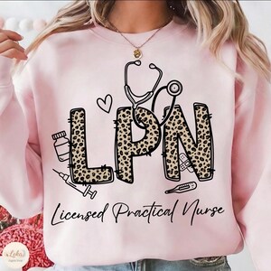 May include: Pink sweatshirt with the letters "LPN" in a leopard print design, a stethoscope, and medical icons. The words "Licensed Practical Nurse" are written below the letters.
