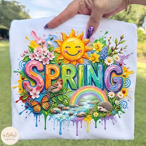 May include: White t-shirt with a colorful "SPRING" graphic. The design features a smiling sun, rainbow, flowers, a bird, butterfly, and hedgehog. The design has a watercolor effect with dripping paint.