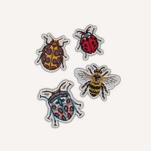 May include: Four embroidered patches featuring insect designs. One patch is a yellow and purple beetle, one is a red and black ladybug, one is a blue, red, and white patterned beetle, and one is a yellow and black striped bumblebee with wings.