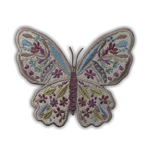 May include: Embroidered butterfly patch with a beige background and colourful floral details. The butterfly has blue, purple, yellow, and red accents. The patch is a decorative item, suitable for clothing or accessories.