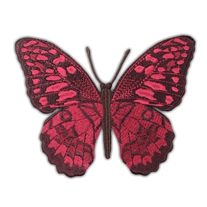May include: Embroidered butterfly patch in shades of red and burgundy. The butterfly has detailed wing patterns and a brown body and antennae. The patch is designed to be sewn or ironed onto fabric.