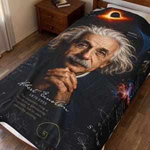May include: A black blanket featuring a portrait of Albert Einstein with his name and birth/death years. The blanket includes scientific diagrams, the text "WARPED SPACETIME", and the quote "The important thing is not to stop questioning. Curiosity has its own reason for existing."