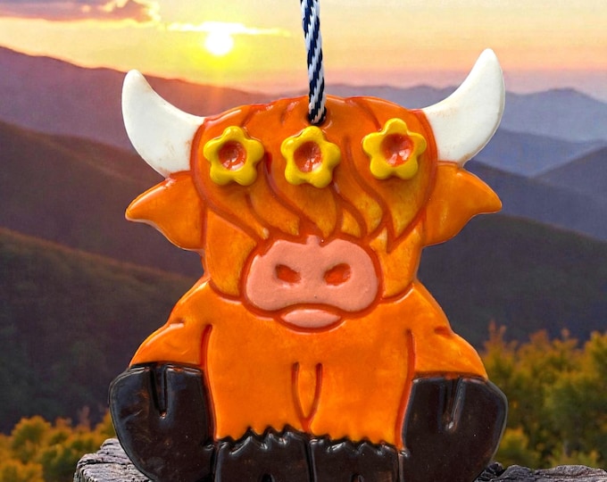 Featured listing image: Handmade Ceramic Highland Cow Decoration with flower garland.