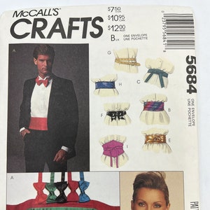 Op de afbeelding: Een naaipatroon voor een cummerbund, strikdas en riem. Het patroon bevat instructies voor het maken van acht riemen, twee stropdassen en een grote cummerbund. Het patroon is van McCall's Crafts en heeft nummer 5684.