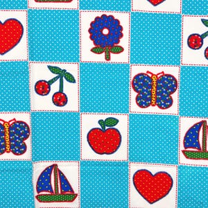 May include: A patchwork fabric with a blue polka dot background and white squares. Each square features a different red and blue applique design, including hearts, flowers, cherries, butterflies, apples, and sailboats. The designs are outlined with red stitching.