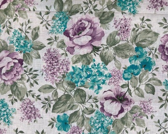 May include: A white fabric with a floral pattern featuring purple and teal flowers. The fabric has a subtle linen texture.