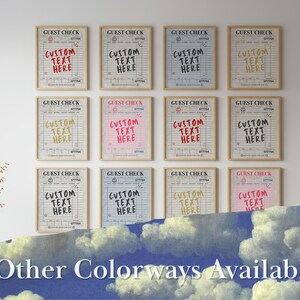 May include: A collection of framed "Guest Check" prints with customizable text in various colors, including red, yellow, and pink. The prints are displayed on a white wall, with a blue sky and cloud design at the bottom. The text "Other Colorways Available" is also visible.