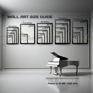 May include: A white grand piano with a black top sits in a room with a wall art size guide. The guide displays various frame sizes in inches and centimeters, including 18x24, 22x28, and 24x36. The piano is 51.96 inches (132 cm) long.