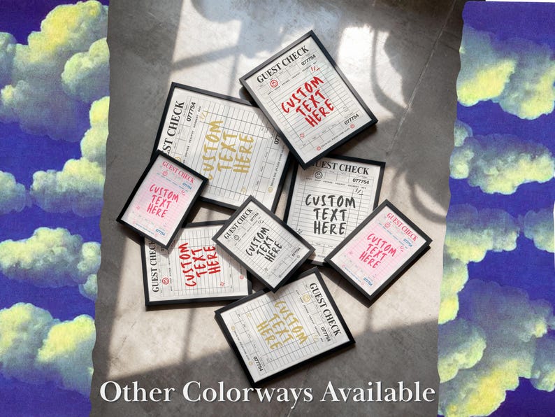 May include: An assortment of framed guest check prints with the text "CUSTOM TEXT HERE" in various colors, including red, pink, and gold. The prints are arranged on a light-colored surface, with the words "Other Colorways Available" at the bottom.