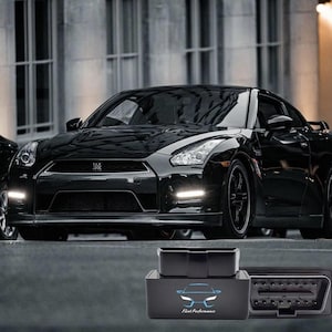 May include: A sleek, black sports car is parked on a city street. The car has a low profile, with a glossy finish. In the foreground, a black Fleet Performance OBD2 scanner is displayed, featuring a car graphic.