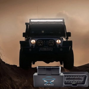 May include: Black off-road vehicle with a light bar on top, parked on a dirt hill. The vehicle has round headlights and a license plate. In the foreground are black diagnostic tools with the text "Fleet Performance" and a car logo.
