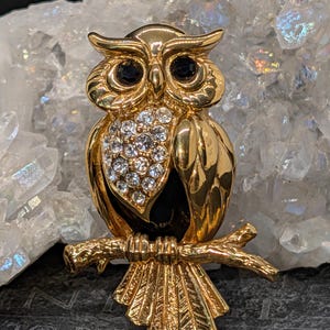 May include: A white ceramic mug with a black handle and the text "But First, Coffee" in a black, bold font. The mug is on a white surface. The mug is 4 inches tall.