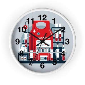 May include: White-framed wall clock with a medical laboratory theme. The clock face features a red blood bag, test tubes, and lab equipment. The words "Blood Bank" are visible on the bag. Black numerals mark the hours against a light gray background.