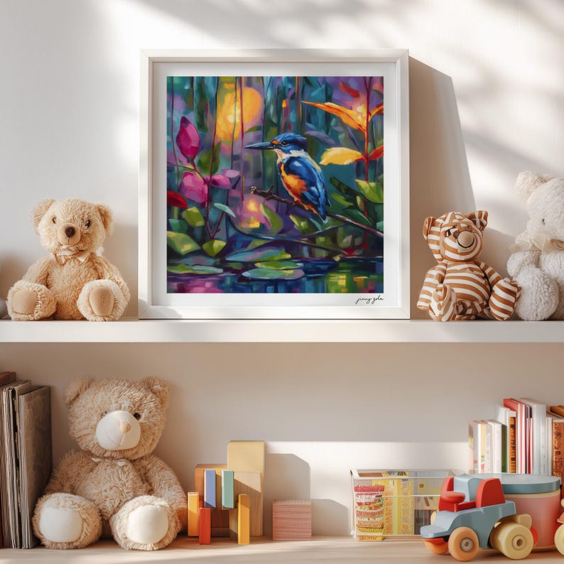 May include: A framed art print depicting a kingfisher bird in a colourful, impressionistic painting. The artwork shows the bird perched on a branch above water lilies, with a palette of blues, oranges, and greens. The print is displayed on a white shelf.