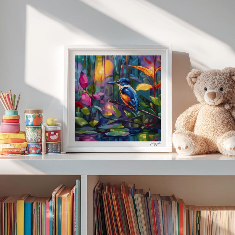 May include: A framed art print showing a watercolour painting of a kingfisher bird on a branch. The bird has blue, orange, and white feathers. The background features colourful foliage and water, creating a tranquil nature scene.