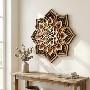May include: A layered wooden wall art piece in a floral design. The artwork features multiple layers of wood in shades of brown, beige, and pink, creating a three-dimensional effect. The piece is mounted on a white wall, adding a natural and decorative element to the space.