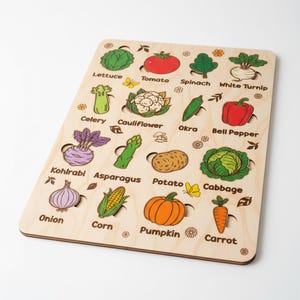 May include: Wooden vegetable puzzle with colourful illustrations of lettuce, tomato, spinach, white turnip, celery, cauliflower, okra, bell pepper, kohlrabi, asparagus, potato, cabbage, onion, corn, pumpkin, and carrot.