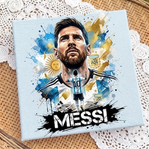 May include: A square canvas print featuring a watercolor-style portrait of Lionel Messi above a smaller figure of the player wearing a number 10 jersey. The design includes the Argentina flag, the AFA logo, and the text MESSI in bold black letters.