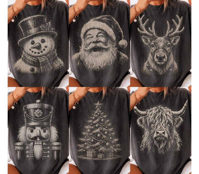 May include: A collection of six charcoal gray t-shirts, each featuring a distinct white graphic print. The designs include a snowman, a laughing Santa Claus, a reindeer, a nutcracker, a decorated Christmas tree, and a shaggy Highland cow.