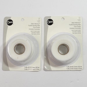 May include: Two packages of Dritz Stitch Witchery fusible bonding web in super and regular weight. Each white roll is mounted on a card with text stating 5/8 in x 20 yd (15 mm x 18.2 m) and 5/8 in x 13 yd (15 mm x 11.8 m) dimensions.