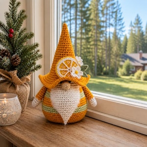 May include: A crochet gnome figurine featuring a tall yellow pointed hat adorned with a white and yellow lemon slice applique and small white flowers. The gnome has a round beige nose, a white beard, and a body with yellow and green stripes.