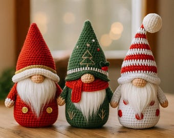 May include: Three handmade crochet gnomes with long white beards and pointed hats. The gnomes are in red, green, and white with festive details like a Christmas tree and red and white stripes. They are displayed on a wooden surface.