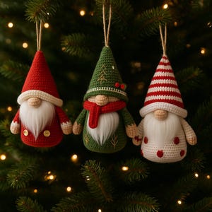 May include: Three handmade Christmas gnome ornaments hanging on a Christmas tree. The gnomes are red, green, and white with long white beards, and each has a different hat design. The ornaments are made of yarn and have a rustic, handcrafted appearance.