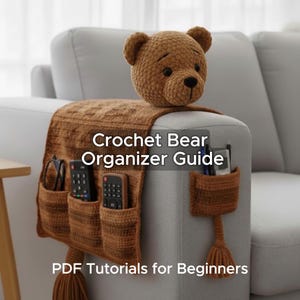 May include: A brown crocheted bear head sits atop a matching brown crocheted couch organizer. The organizer has pockets for remotes and other items. Text on the organizer reads "Crochet Bear Organizer Guide" and "PDF Tutorials for Beginners."