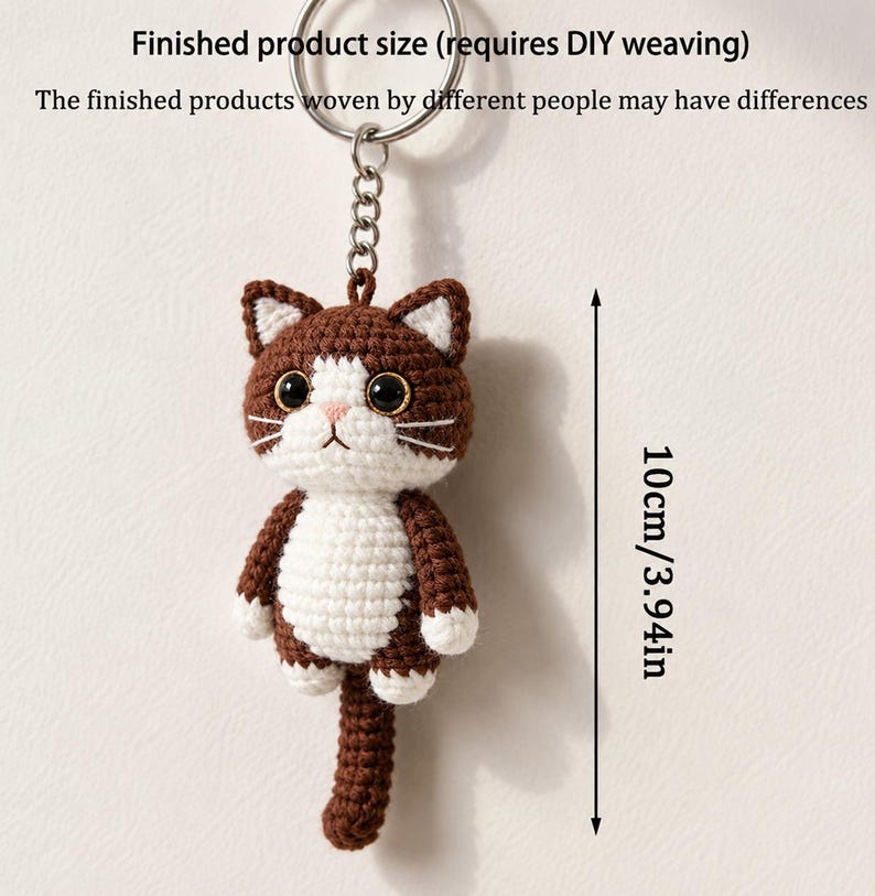 May include: A handmade crochet cat keychain, featuring brown and white yarn. The cat has a detailed face with black eyes, a pink nose, and white whiskers. The finished product size is 3.94 inches (10cm).