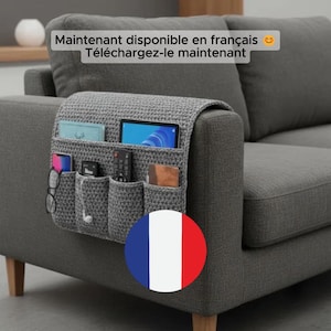 May include: A grey crocheted sofa armrest tidy with several pockets, holding a tablet, remote, phone, glasses, and other items. The organiser is attached to a grey sofa. French text is visible at the top.