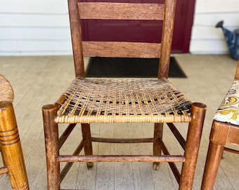 Cadeira vintage com encosto em forma de escada e assento trançado à mão.