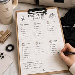 May include: A clipboard with a checklist titled "Practice Night Reset" is being filled out with a pen. The checklist includes sections for uniforms, laundry, ice packs, lunches, water bottles, and bedtime reset. A Stanley tumbler and a beige bag are in the background.