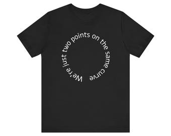 May include: Black t-shirt with a white circular design. The design features the text "We're just two points on the same curve" in a circular arrangement. The shirt is made of a soft material and has short sleeves.