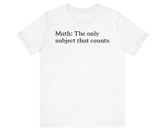 May include: White t-shirt with the text "Math: The only subject that counts" printed in black. The shirt is made of a soft material and has a crew neck. A casual tee for math enthusiasts.